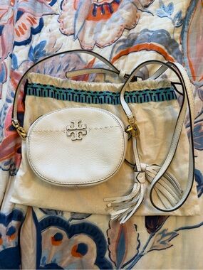 Tory Burch Off White Pebbled Leather Oval Crossbody with Tassel